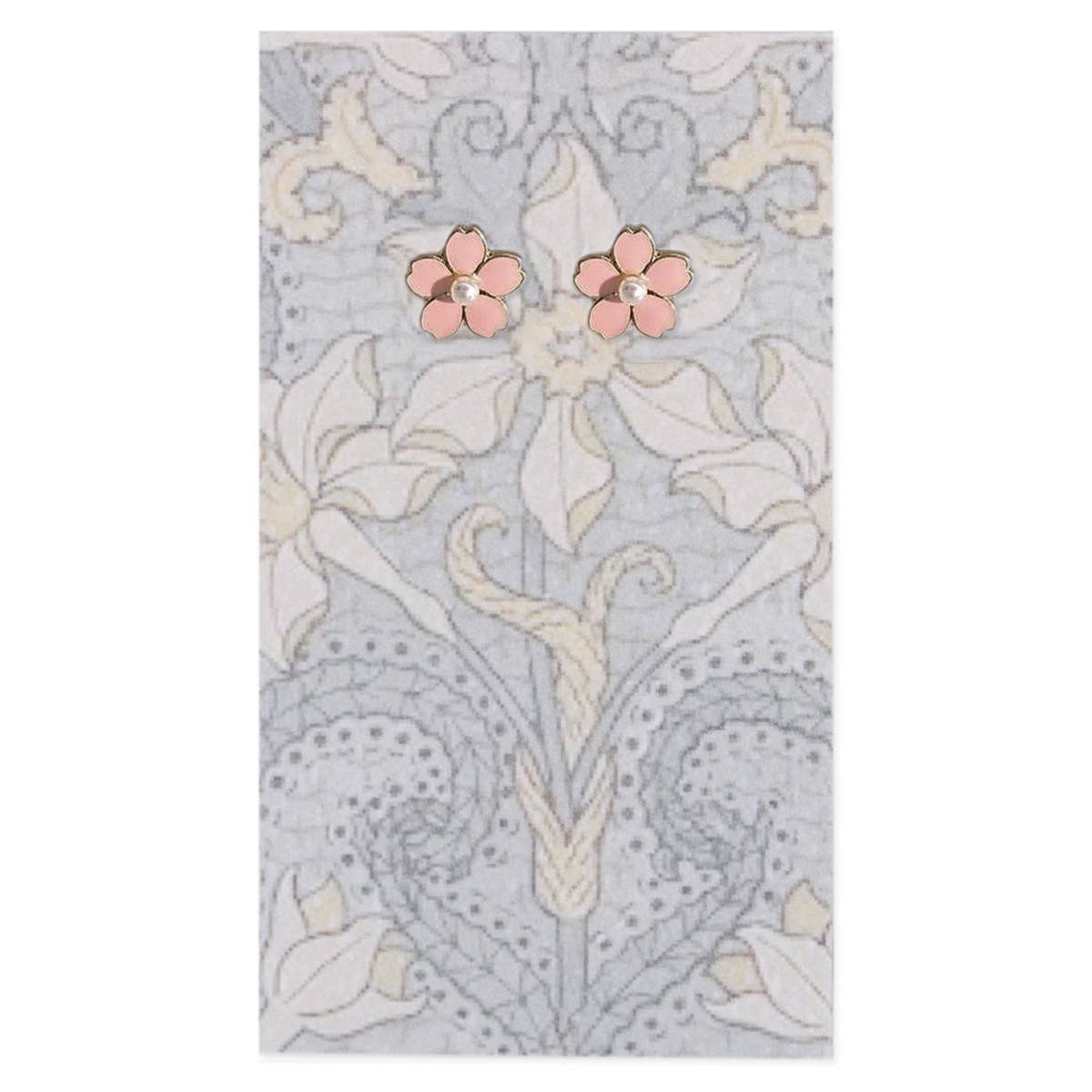 Pink floral earrings on a decorative fabric background