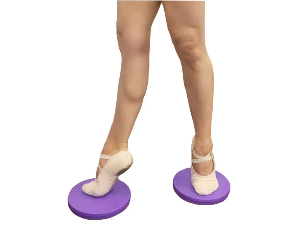 Person wearing ballet shoes on purple turnout boards against a white background