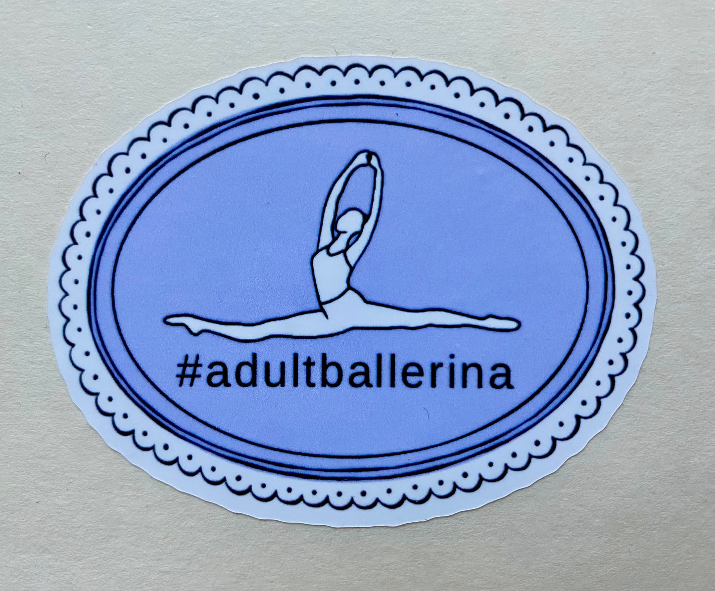 Sticker with a dancer illustration and '#adultballerina' text on a blue oval background