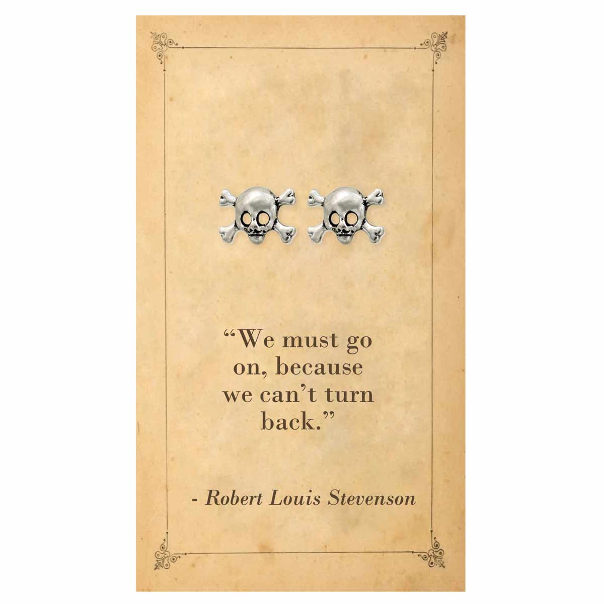 Skull and crossbones earrings on a decorative card with a quote by Robert Louis Stevenson.