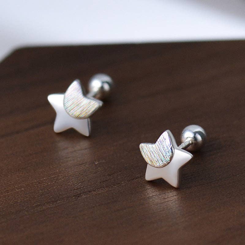 Star-shaped earrings on a wooden surface