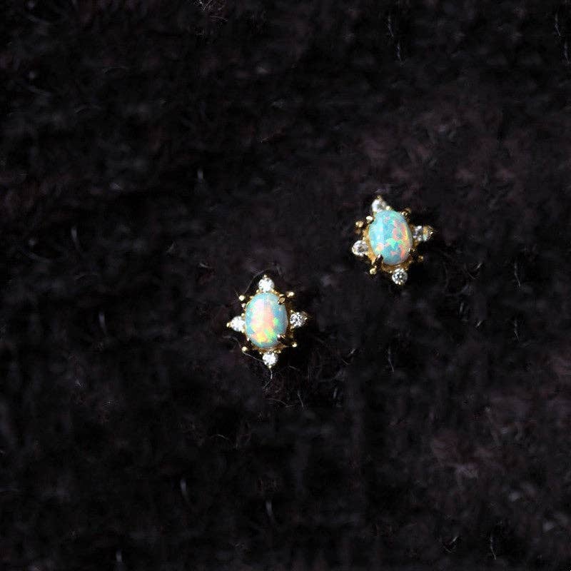 Pair of opal stud earrings on a black background