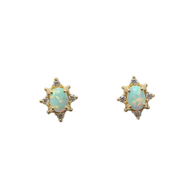 Pair of gold earrings with opal stones on a white background