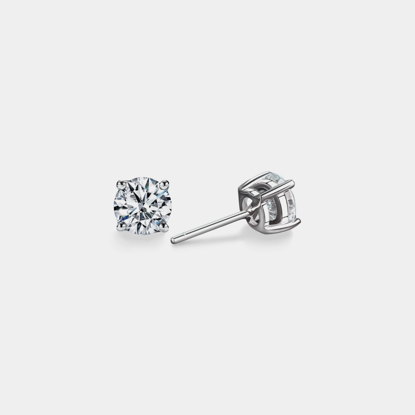 Diamond stud earrings on a light gray background