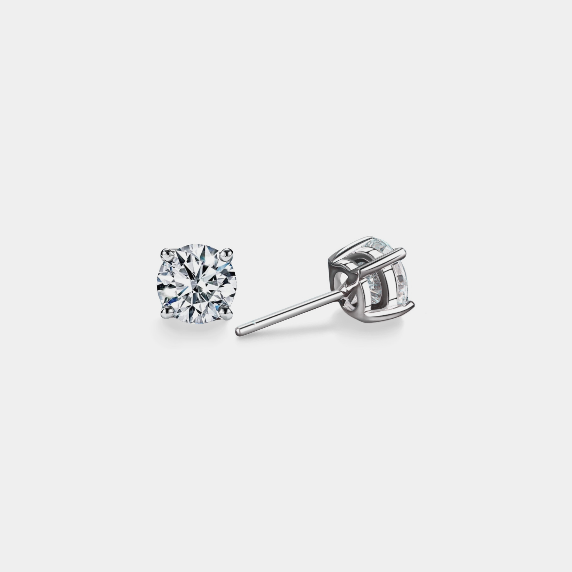 Diamond stud earrings on a light gray background