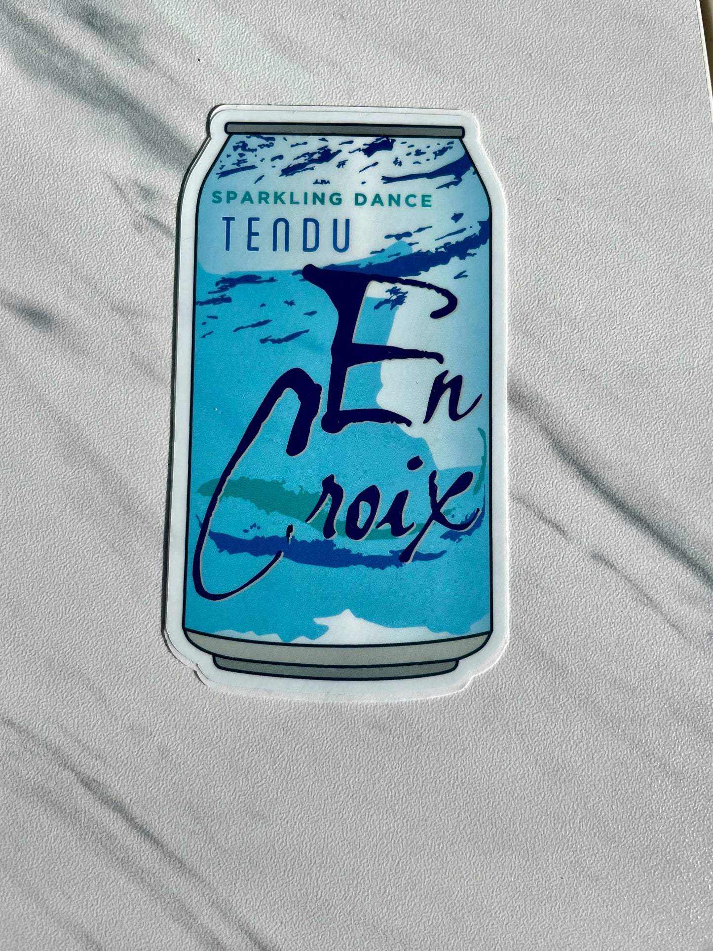 Sticker of a blue can with text on a gray background