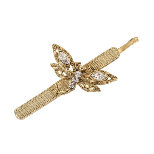 Gold dragonfly hair clip with decorative design and crystals on a white background