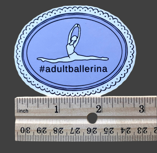 Oval-shaped sticker with a dancer illustration and '#adultballerina' text, measured against a ruler for scale.