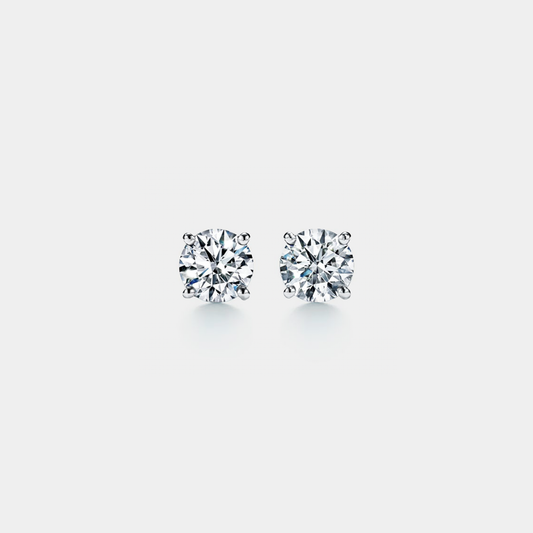 Pair of moissanite stud earrings on a light gray background