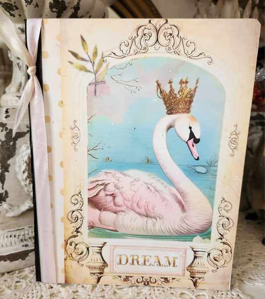 Decorative book with a swan illustration and 'Dream' text on a decorative surface.