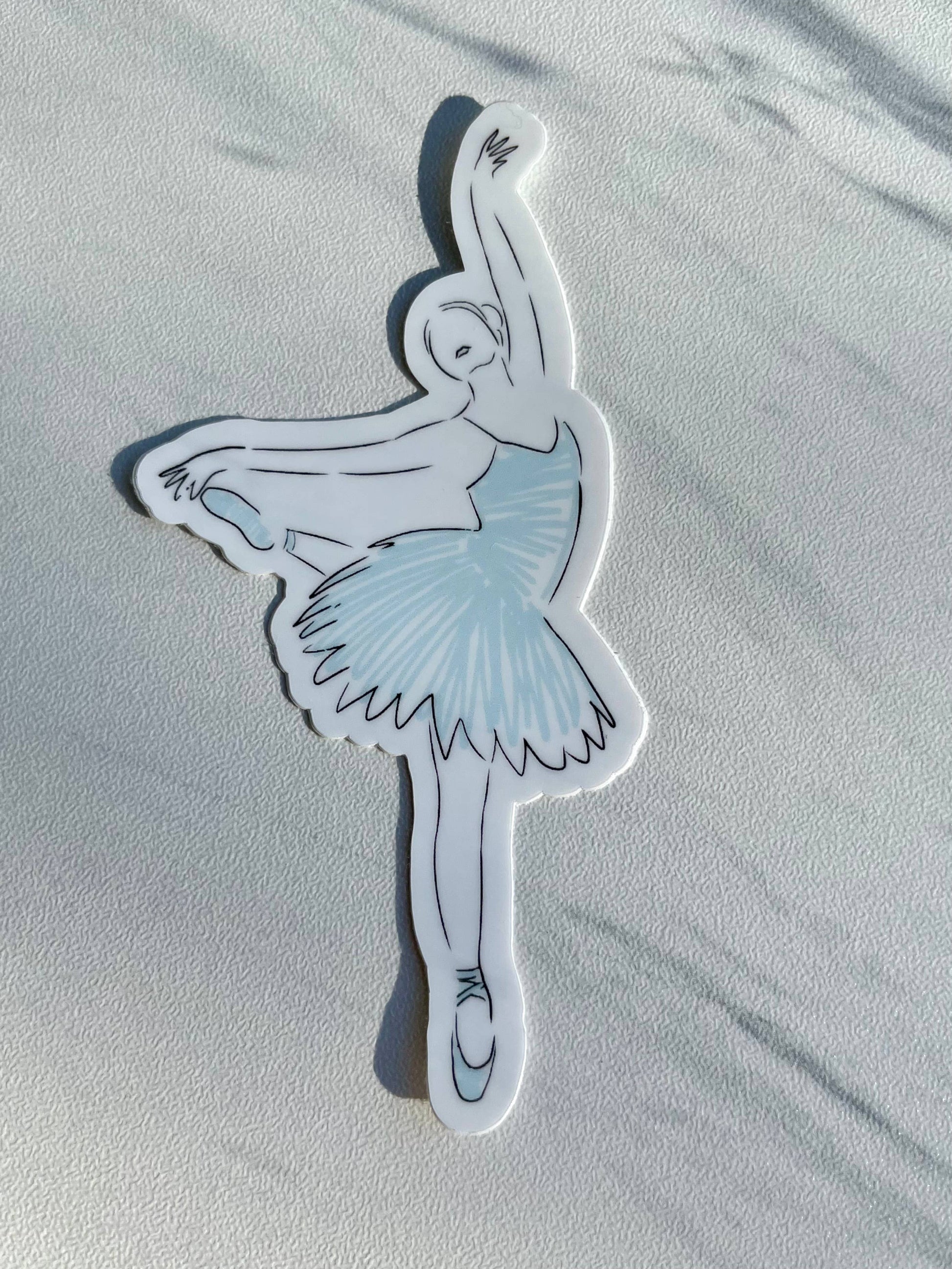 Sticker of a ballerina in a blue tutu on a light gray background