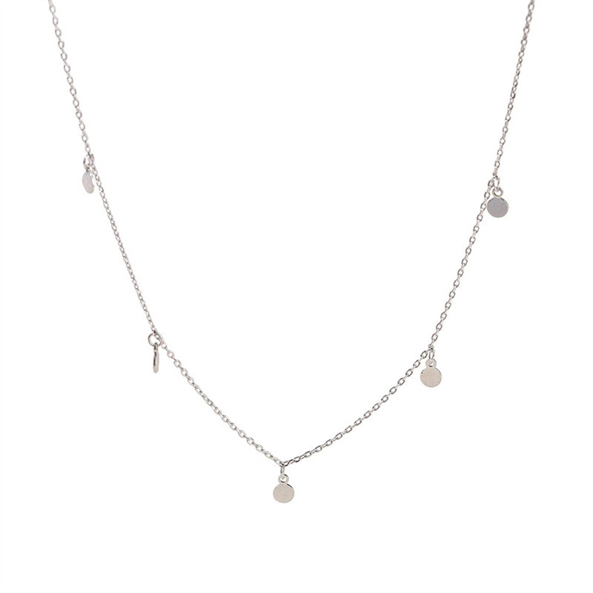 Silver necklace with small round pendants on a white background