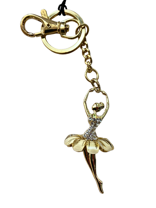 Gold keychain with a ballerina charm on a white background