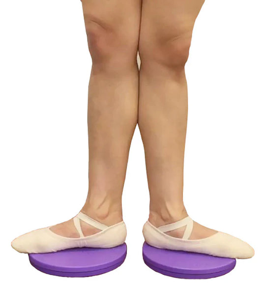 Person wearing ballet shoes on purple turnout boards with a white background