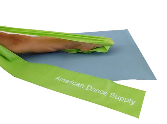 Green resistance band with 'American Dance Supply' branding on a blue mat.