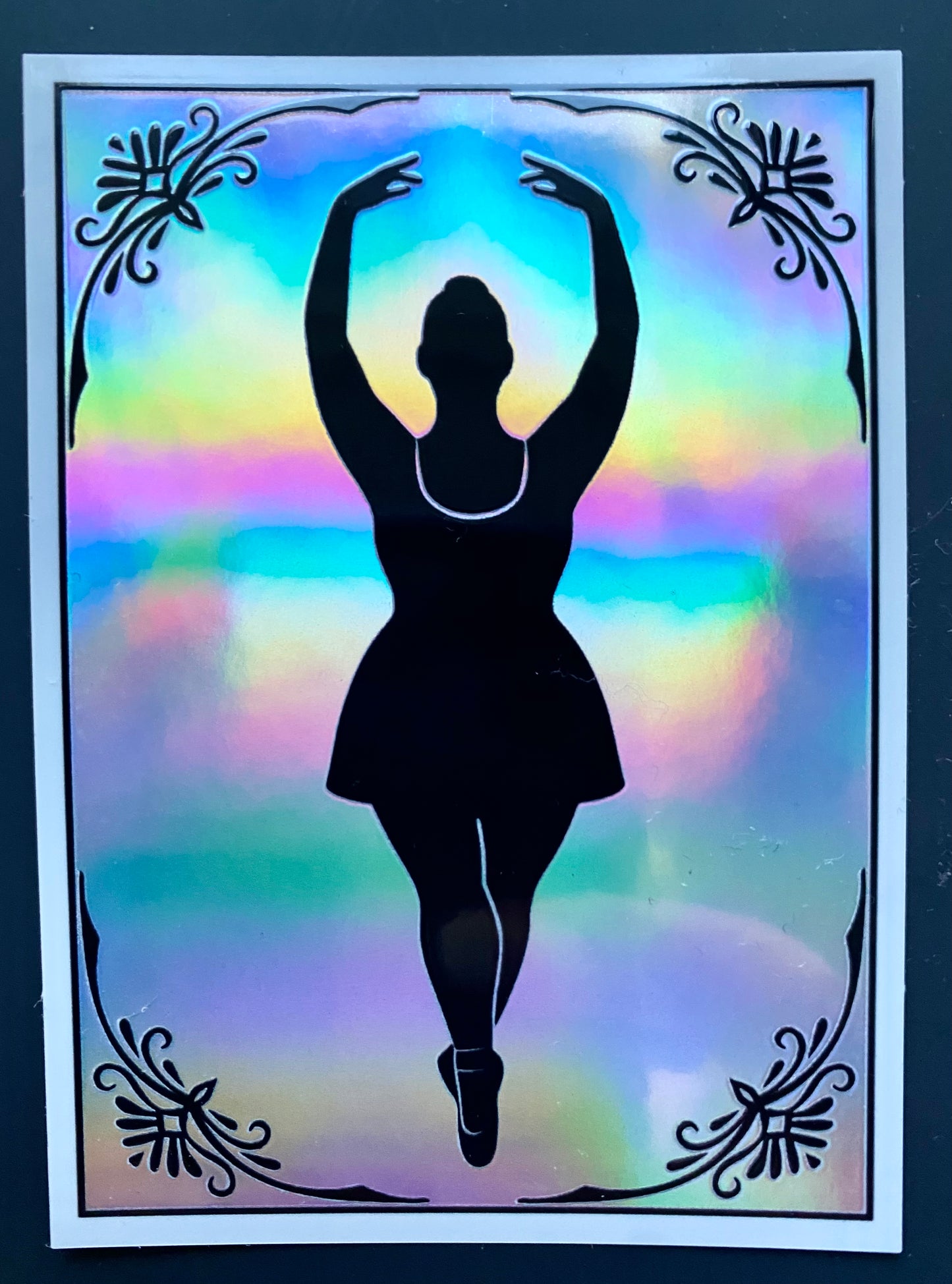 Silhouette of a dancer against a colorful, gradient background with decorative elements.