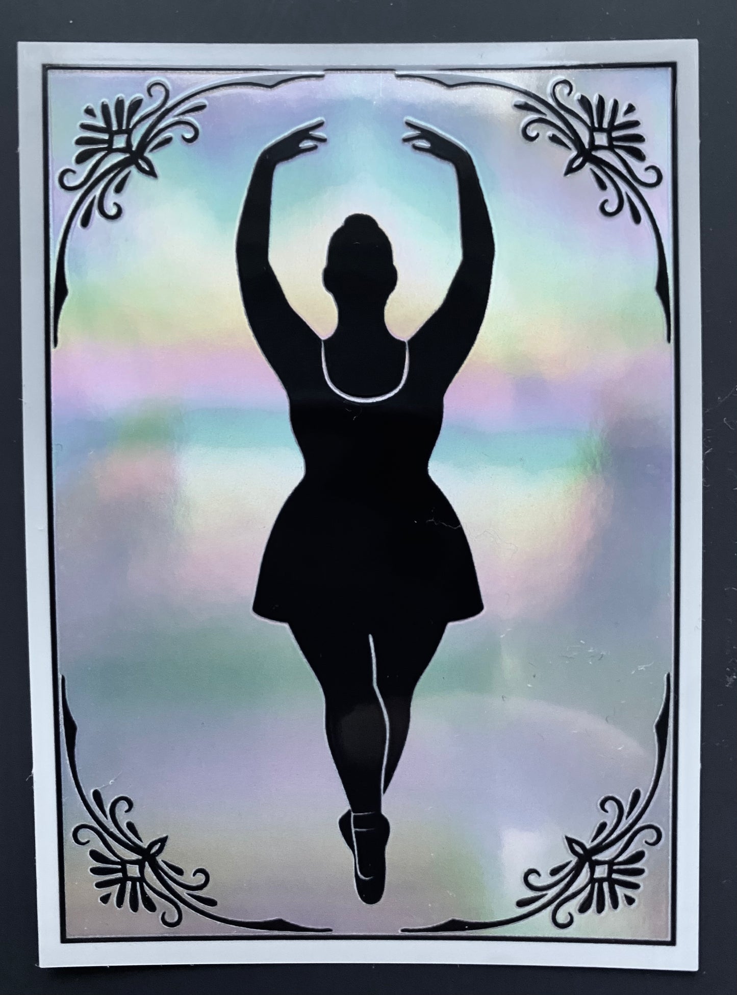Silhouette of a dancer against a colorful, blurred background with decorative elements.