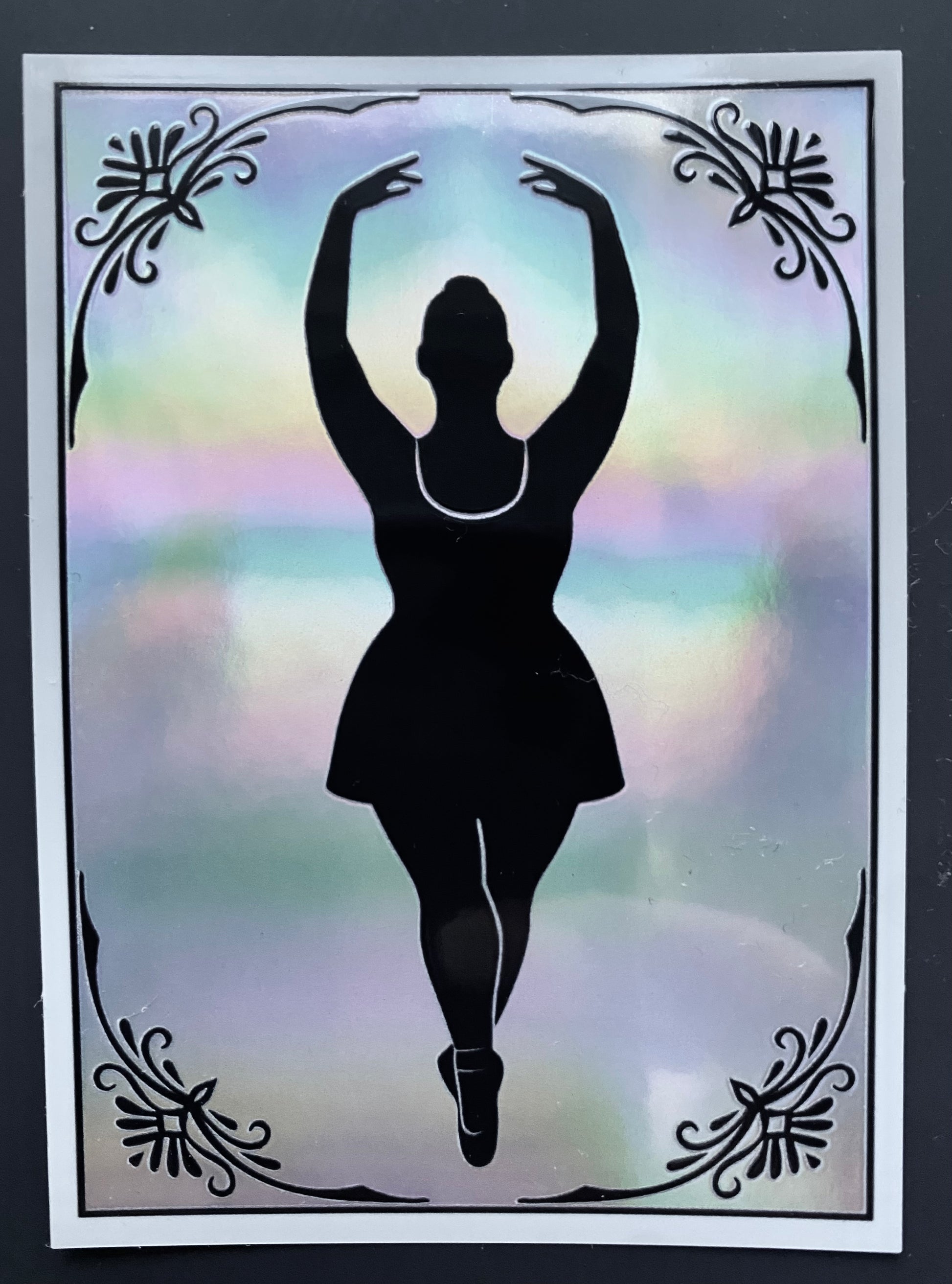 Silhouette of a dancer against a colorful, blurred background with decorative elements.