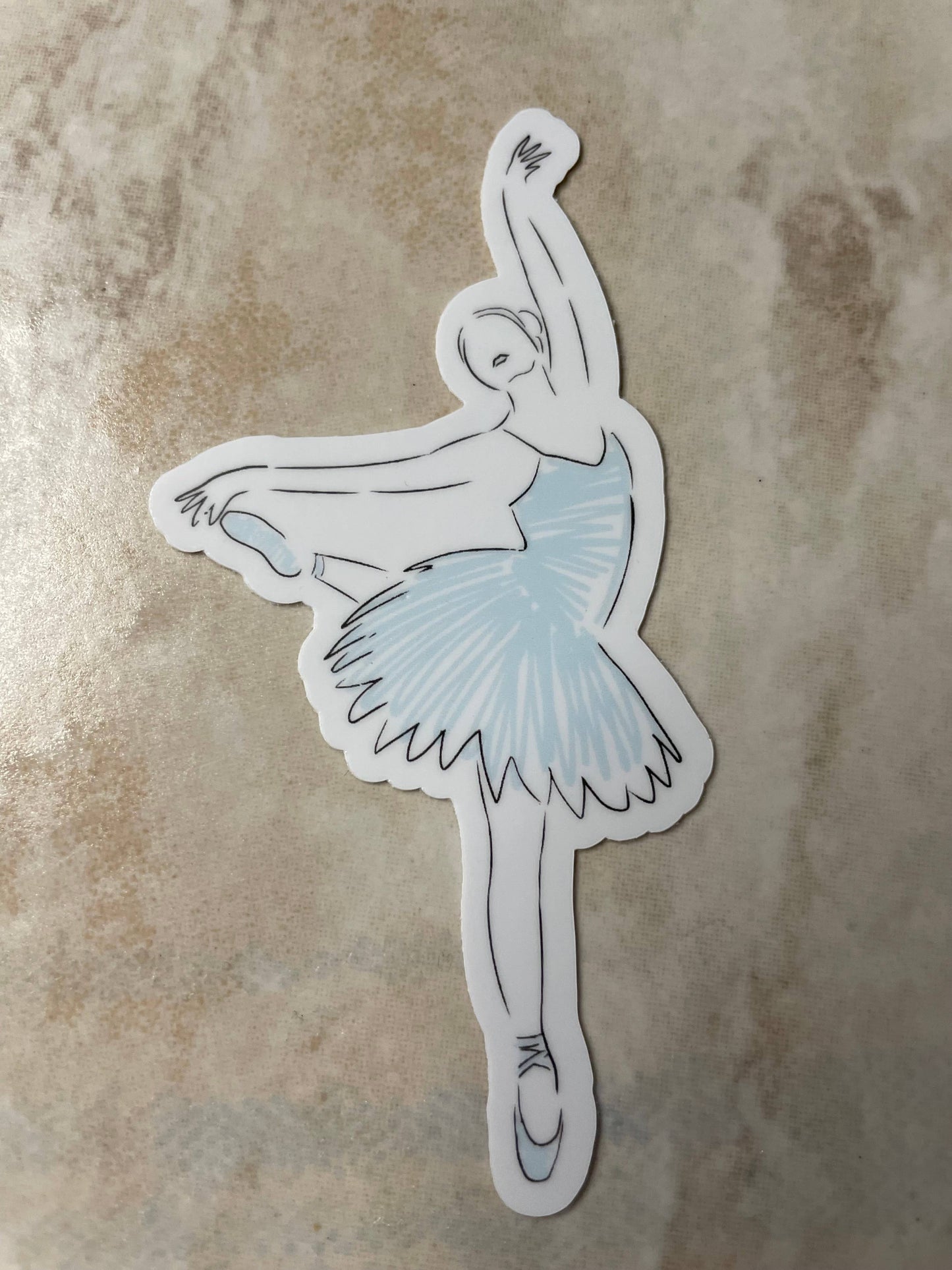 Sticker of a ballerina with a blue tutu on a textured beige background