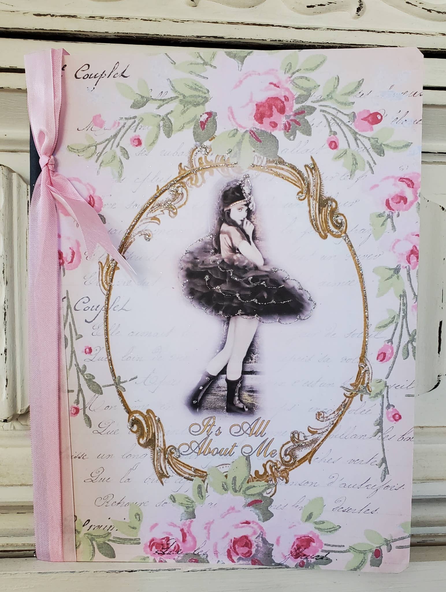 Decorative notebook with floral design and illustration of a ballerina on a white background