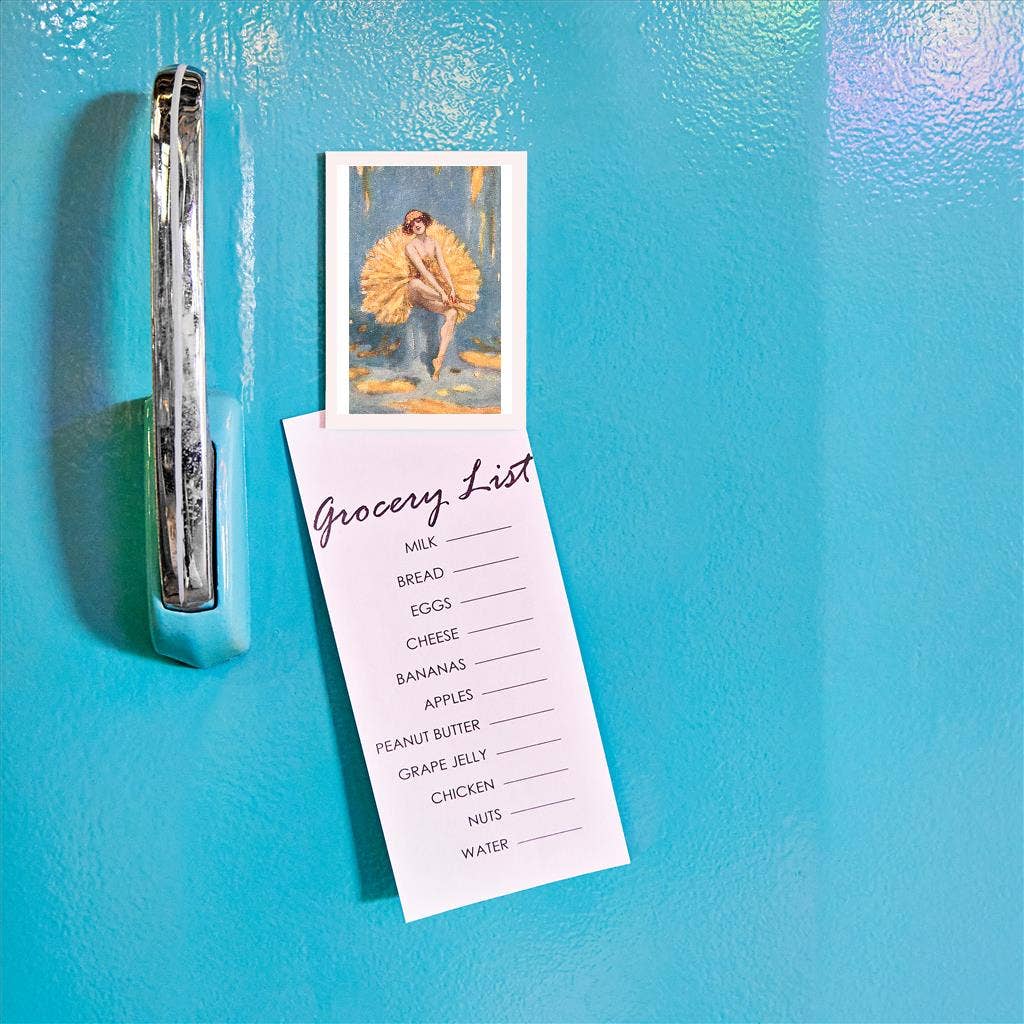 Grocery list attached to a refrigerator with a magnet of a dancer
