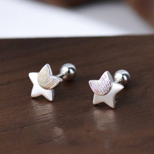 Star-shaped earrings on a wooden surface